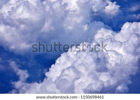  white fluffy clouds on the blue sky from plane window 
