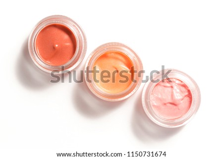 Creamy make up products - top view of decorative cosmetic containers isolated on white backgroiunds