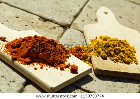 Spices - curry powder and pepper powder on cutting boards. 