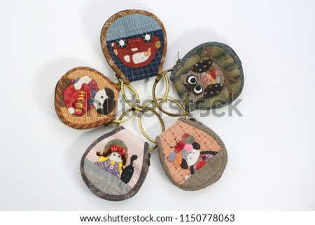 Quilting product. Key ring home pattern of quilt. Homemade Japanese quilt. Japanese handcraft on white background. Signed property release. Selective focus and toned image. Design idea concept.