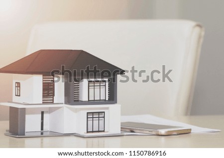Real estate agent house represented by model;with background woman agent business.Real estate value concept.
