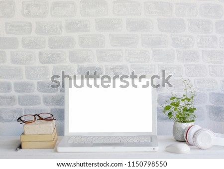 Mock up Laptop Computer Background White Brick Wall, Books, glasses, earphones