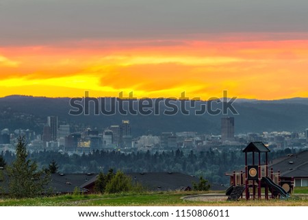 Portland Oregon downtown city skyline by childrens playground in Altamont Park on Mt Scott during sunset