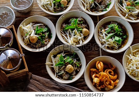 Noodles with pork and pork balls with soup Thai style.Boat culture noodles style. Top view Royalty-Free Stock Photo #1150854737