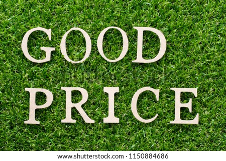 Wood alphabet in word good price on artificial green grass background