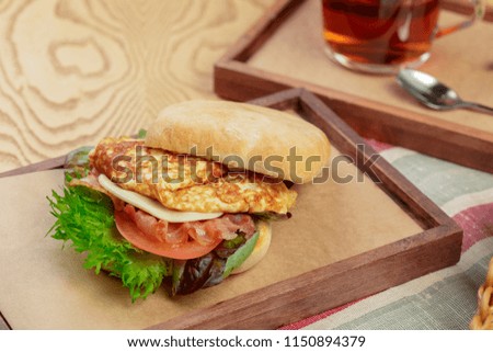 Delicious burger with omelette breakfast dish close up