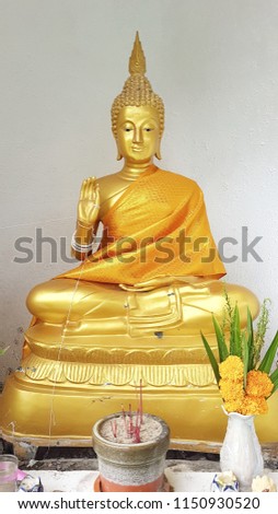 Golden Buddha. For the background picture postcards advertising detrimental impacts on Buddhism.