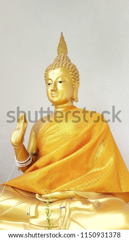 Golden Buddha. For the background picture postcards advertising detrimental impacts on Buddhism.