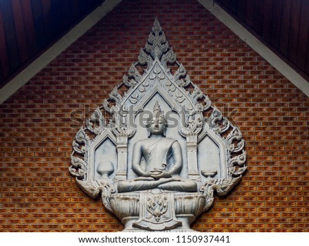 White image of Buddha on the wall 