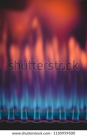 Close-up shot of beautiful blue and red colorful flame of burning gas in industrial heater