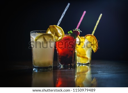 Fresh cocktail on a black background. Alcoholic cocktail on a black background. Fruit with a cocktail. Non-alcoholic cocktail. Mix of cocktails on a black background. Royalty-Free Stock Photo #1150979489