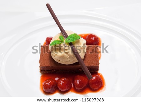 ice cream on the top of a chocolate brownie on white dish background.