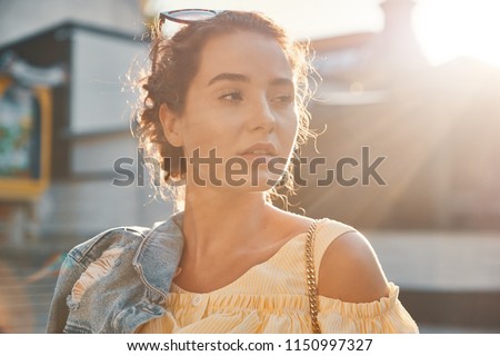 Young woman face in sunlight, portrait. Atmospheric photo.