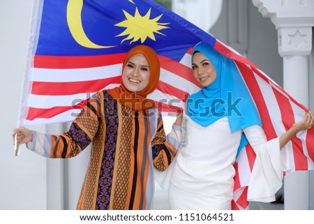 portrait of young beautiful Asian woman with Malaysian flag. independence day.