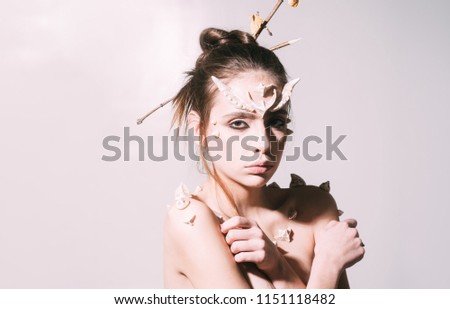 Woman with horns and thorns fantasy creature. Mystic fairy tail character. Halloween ideas concept. Girl with thorns as devil dragon magical creature. Girl fantasy style makeup. Diabolic appearance.