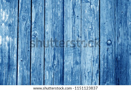 Old grunge wooden fence pattern in navy blue tone. Abstract background and texture for design.