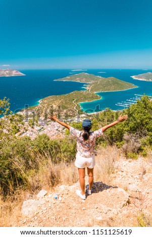 young woman hiking up , Panoramic view from the mountain over the Kas rivera ,hiking up Lycian trail mountain of Kas Turkey