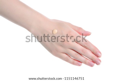 Swatch  of foundation on the hand isolated on white.