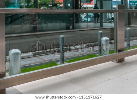 Glass railing on walkway, space for logo or text.