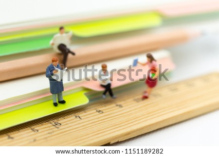 Miniature people: Students read books . Image use for learning, education concept.