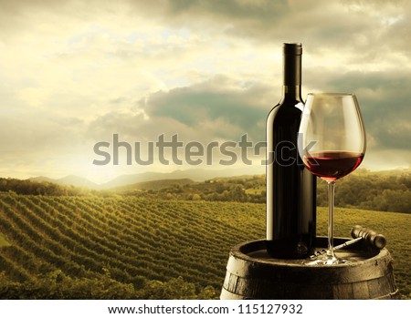 red wine bottle and wine glass on wodden barrel Royalty-Free Stock Photo #115127932