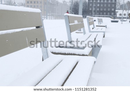 Bench in winter park covered with snow. Winter in the City. 