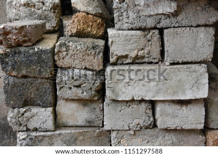 Closeup photograph of stacked concrete bricks used for construction works.