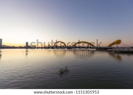 The sunrise on the Han River, Dragon Bridge, Da Nang, VietNam. Da Nang marks the halfway point between the capital in the north, Hanoi, and Ho Chi Minh City in the south. It’s the fourth largest city 