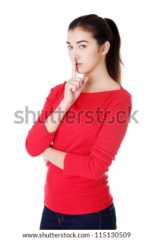 Woman making a keep it quiet gesture , isolated on white