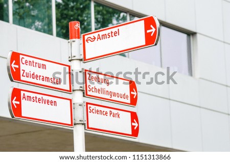 Red and White Directional Signs along a Bicycle Path in Amsterdam City Centre.