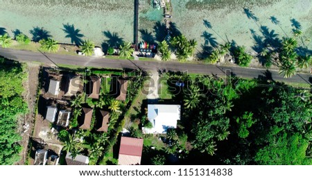poonton and house at the edge of a lagoon in aerial view, french polynesia