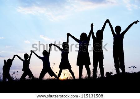 Children silhouettes holding hands up