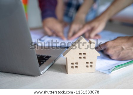 woman civil architect engineer discussion of building with building plan,engineering and architecture concept.Blue print is fake only for stock photo.