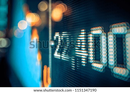 stock market numbers and city light reflection