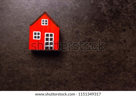 Flat lay red cute wooden house model texture background. House and business concept with free copy space.