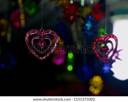 Pink heart shape hanging showpieces isolated unique blurry photo
