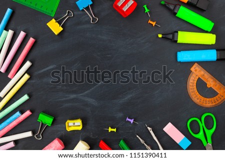 Back To School concept. School supplies on blackboard background, accessories for the schoolroom - pencils, scissors, chalk, markers. Сopy space top view