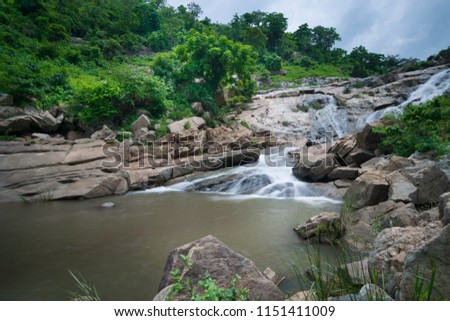 Beautiful Ghatkhola waterfall having full streams of water flowing downhill amongst stones , duriing monsoon due to rain at Ayodhya pahar (hill) - at Purulia, West Bengal, India.