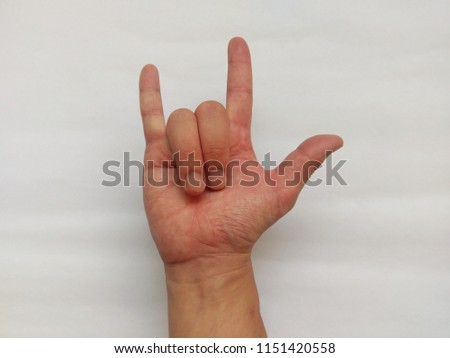 Right hand “I Love You” gesture (underhand). Asian hand model. Isolated