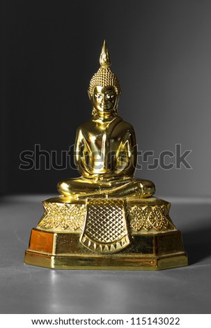 Gold Buddha statue on black background