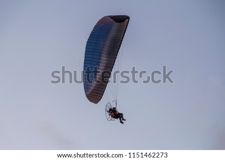 Paramotor, motor-powered paragliding parachute in the sky