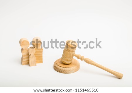 Figures of the family and the hammer of the judge. Concept of judicial system for human rights. Family matters, the adoption of a child. Weddings and divorce. Deprivation of parental rights Royalty-Free Stock Photo #1151465510