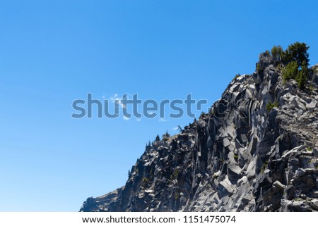 View of cliff that surrounds crater lake