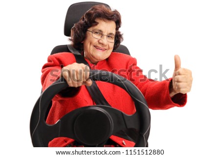 Senior lady driving and holding her thumb up isolated on white background