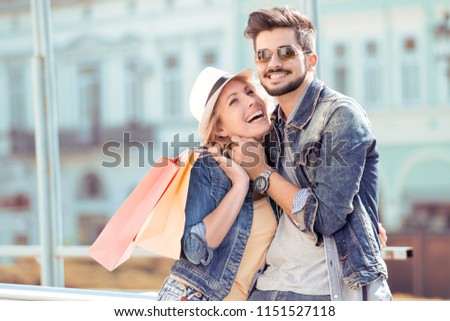 Picture showing young couple shopping in the city.