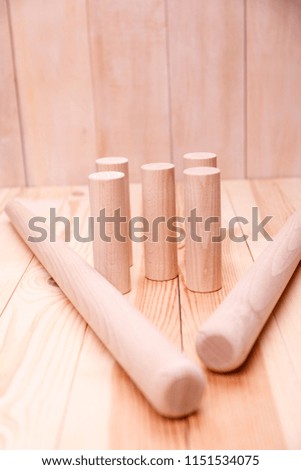 A wooden stick with a toy. Wooden background