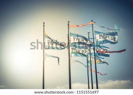 Vintage tone beautiful Pier 39 flags waving in the wind at sunset blue sky, San Francisco, California, USA
