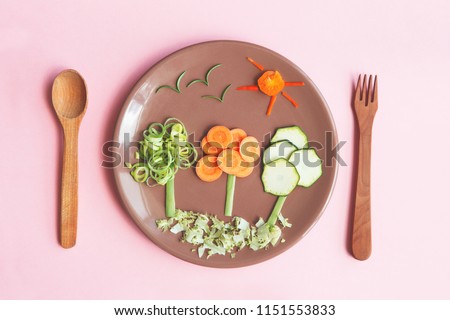 creative and healthy kids meal, cute trees made of fresh tasty vegetables and herbs, carrots, zucchini, onion, red pepper and rosemary, wooden spoon and fork on bright pink background, flat lay Royalty-Free Stock Photo #1151553833