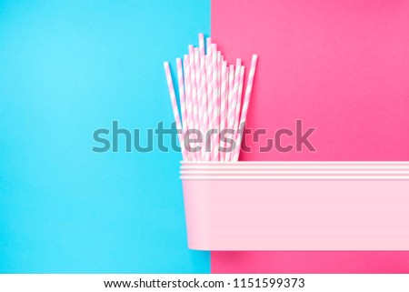 Stacked Drinking Paper Cups with Striped Straws on Duo Tone Light Blue Pink Background. Flat Lay. Birthday Party Celebration Kids Fun. Greeting Card Poster Template. Copy Space. Pixel stretch glitch