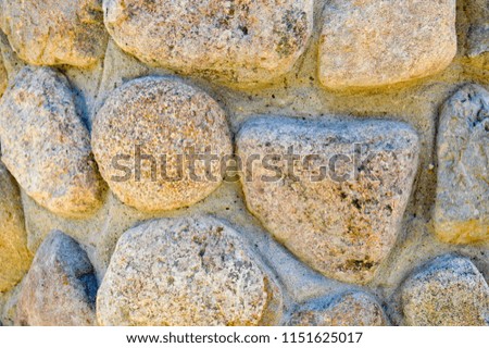 Texture of natural natural carved solid strong rough rough sharp textured mineral gray brown stone cobblestone on the walls of the rock. Stone background.